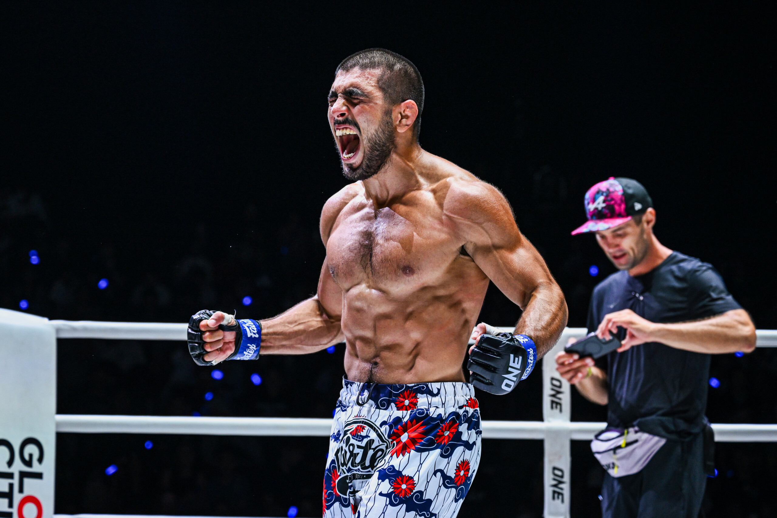 MMA fighter Elbek Alyshov celebrates his win in the ring